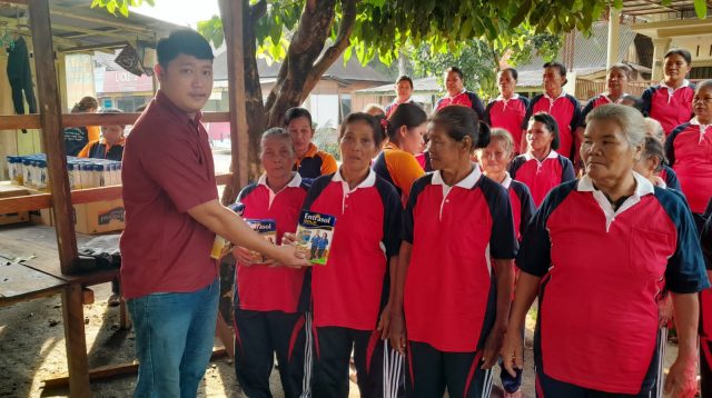 Foto : Kepala Desa Pasaribu Tobing, Diswanto Hutagalung membagikan makanan tambahan kepada lansia